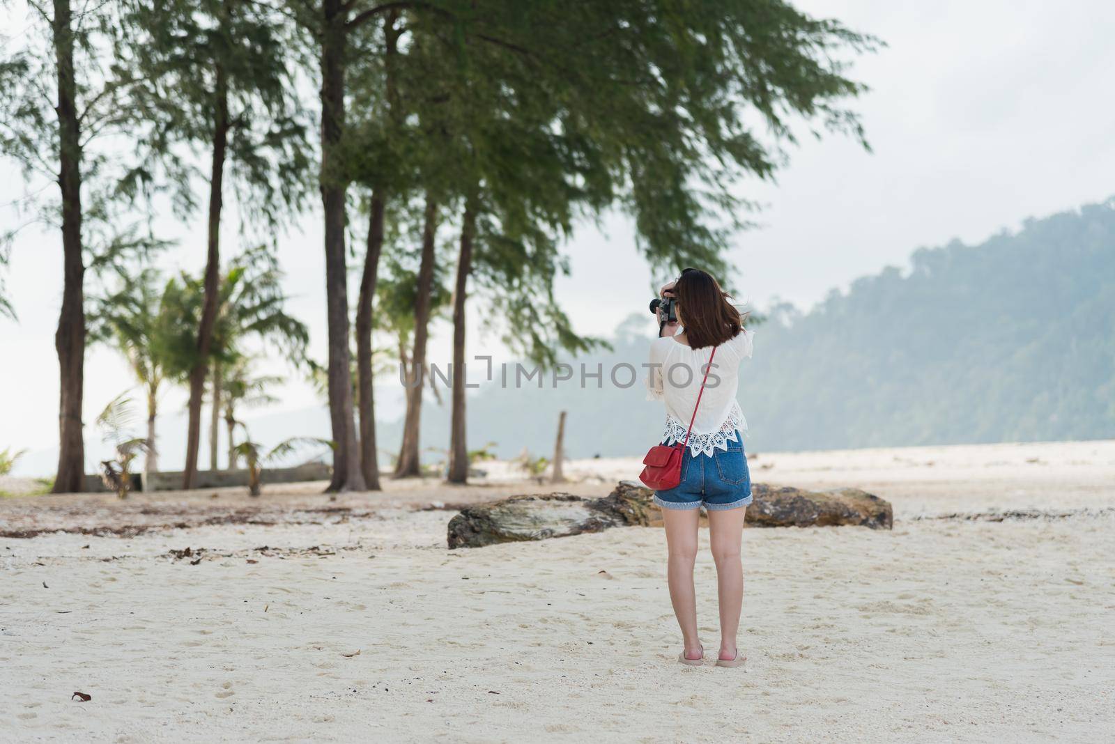 asia girl take photo on the beach