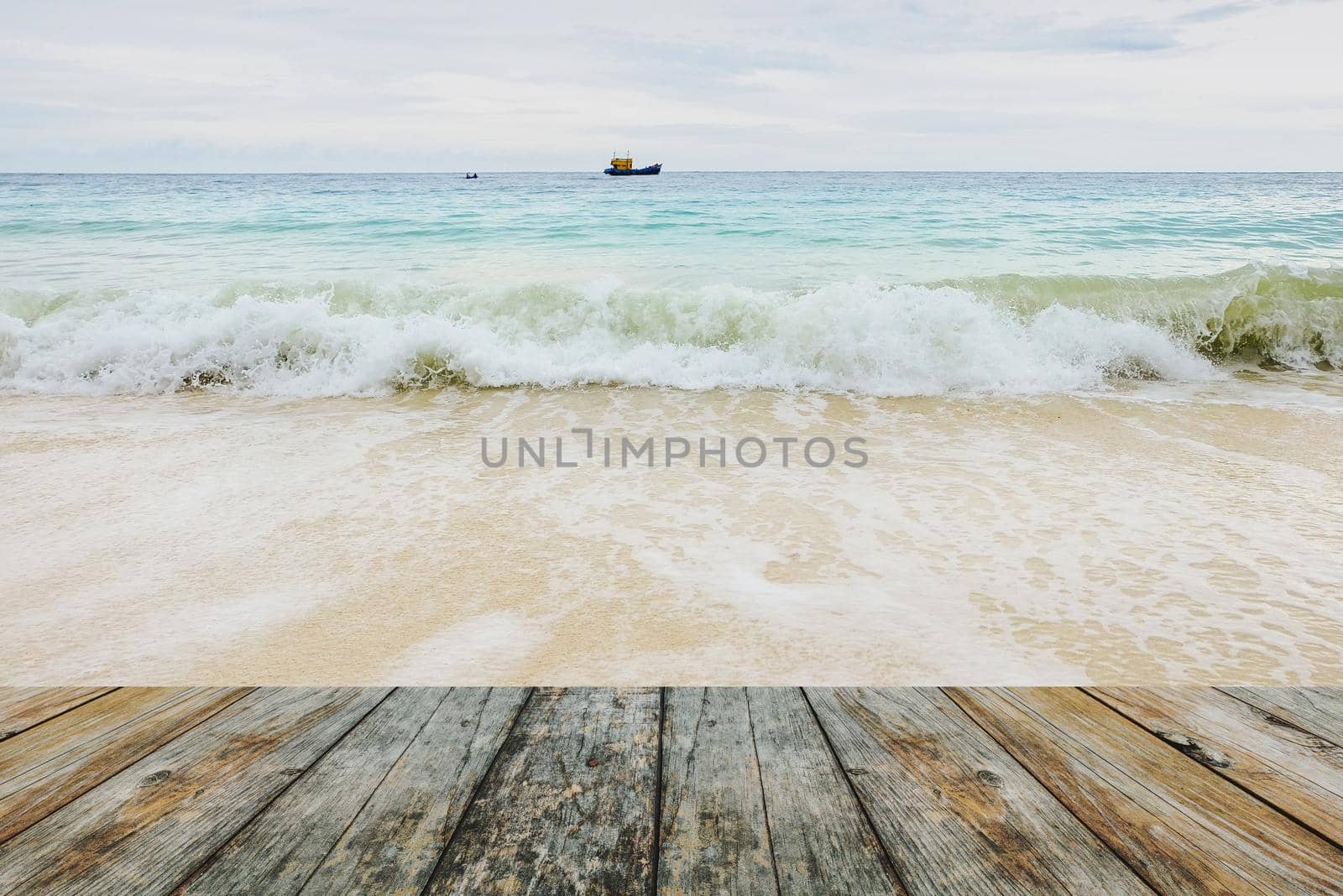 Wood floor on waves crashing on the beach by Wmpix