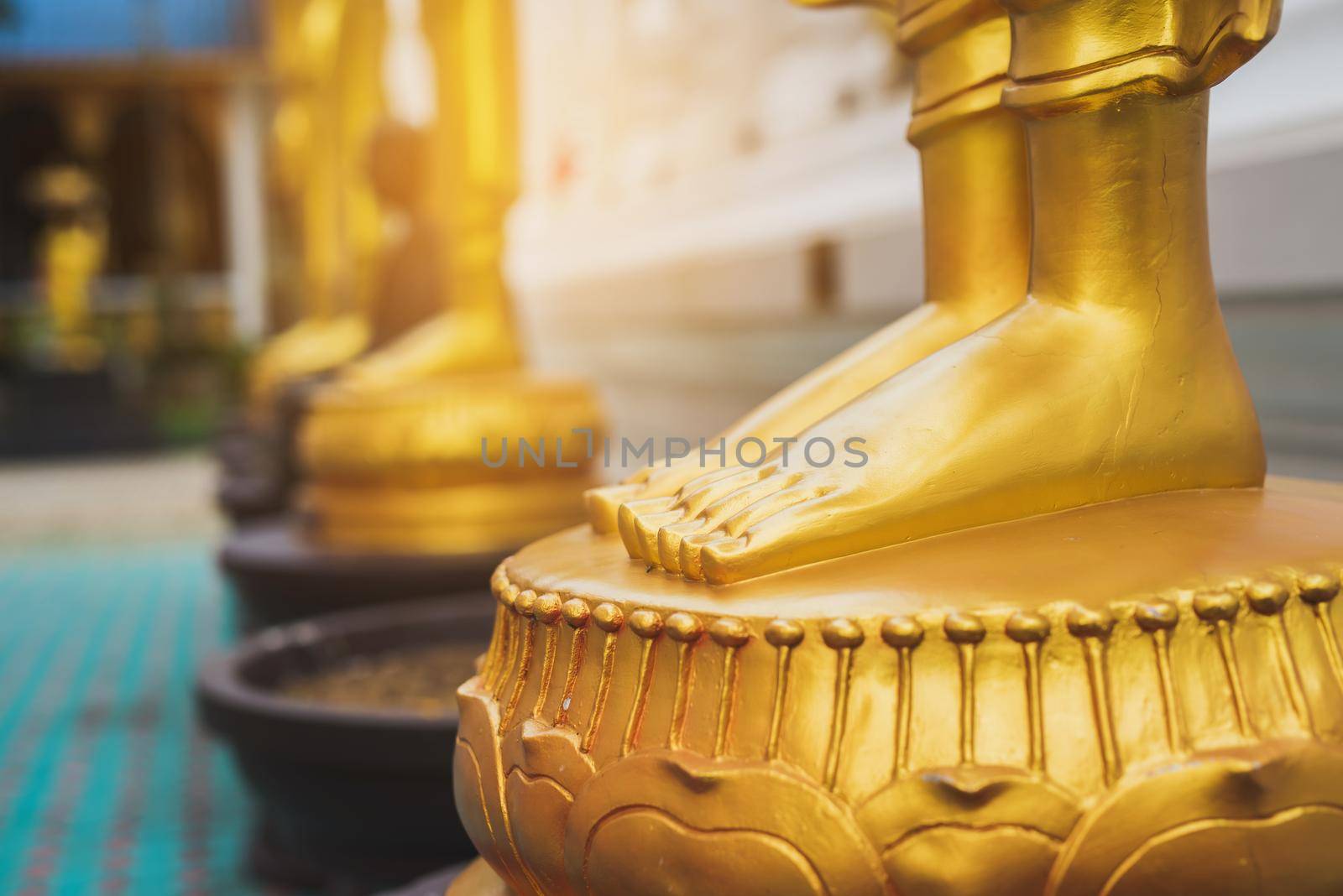 feet of Golden Buddha statue by Wmpix