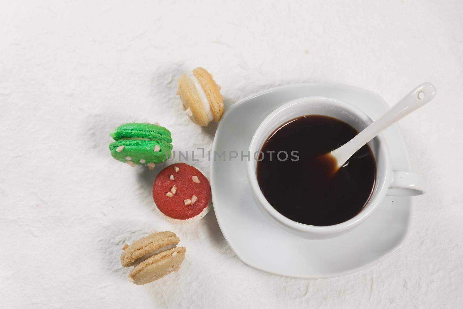 colourful french macaroons with cup of coffee