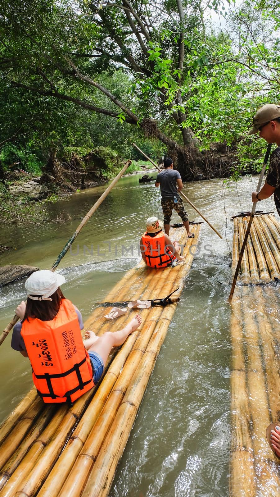 CHIANG MAI, THAILAND - JULY 18: Tourists are rafting trips in the creek with bamboo float rafting on July 18,2016 in Chiangmai Thailand -Northern Thailand by Wmpix