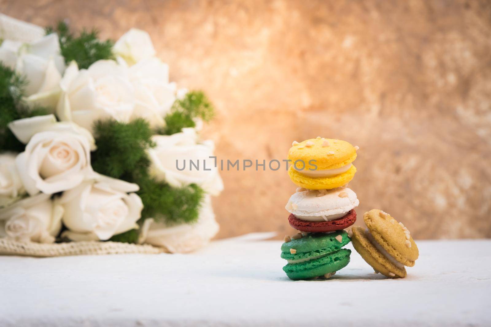 colourful french macaroons with white rose by Wmpix