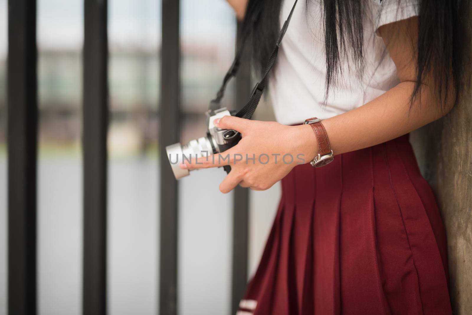 Girl with vintage camera in the hands by Wmpix