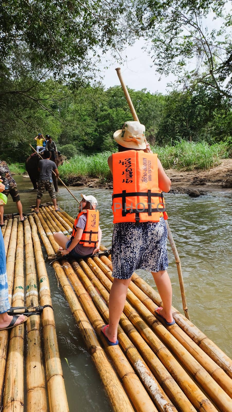 CHIANG MAI, THAILAND - JULY 18: Tourists are rafting trips in the creek with bamboo float rafting on July 18,2016 in Chiangmai Thailand -Northern Thailand by Wmpix