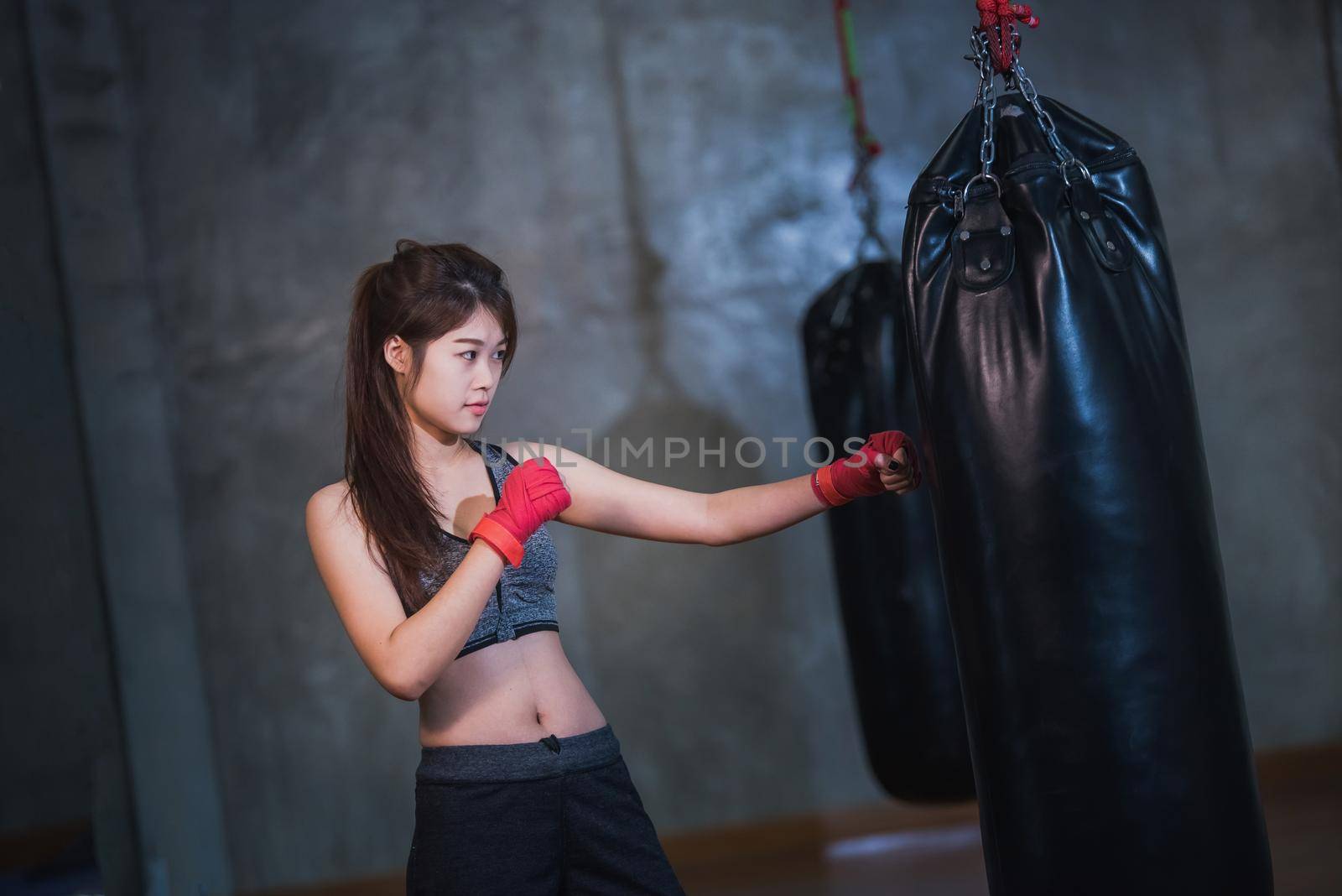 sexy asia girl punching boxing bag