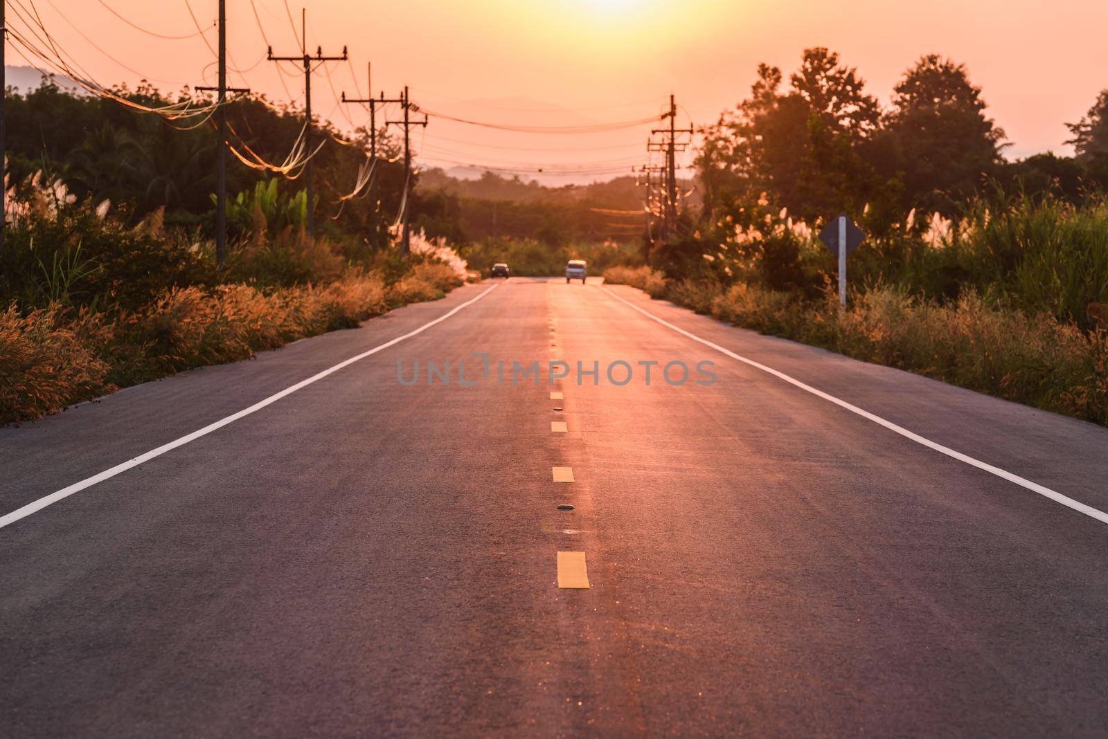 sunset over asphalt road