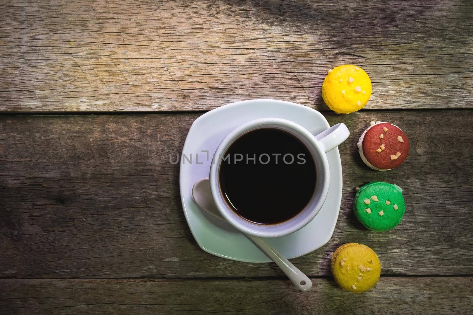 macaroon and cup of coffee on wood table by Wmpix