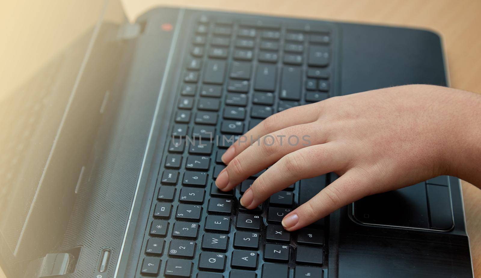 Close up of female hands typing on keyboardand Hand Lies On The Laptop Keyboard