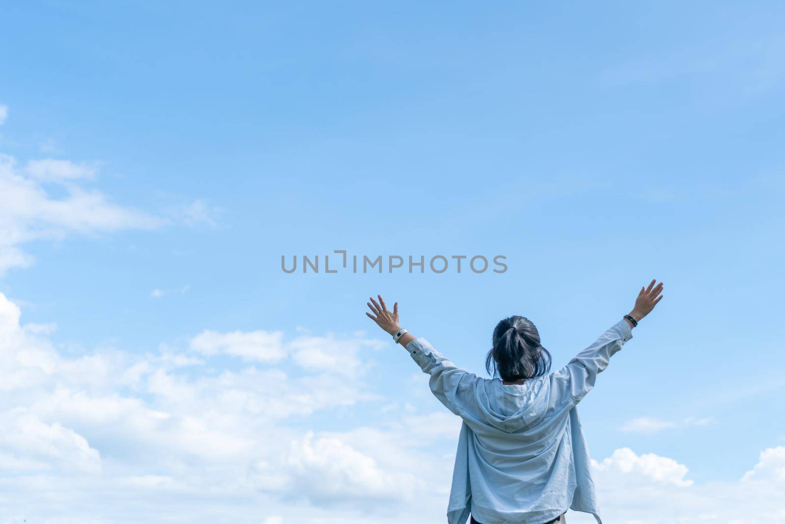 Copy space freedom lady hand rising up summer vacation and freedom concept blue sky and mountain in abstract summer background. Vintage clean color tone style 