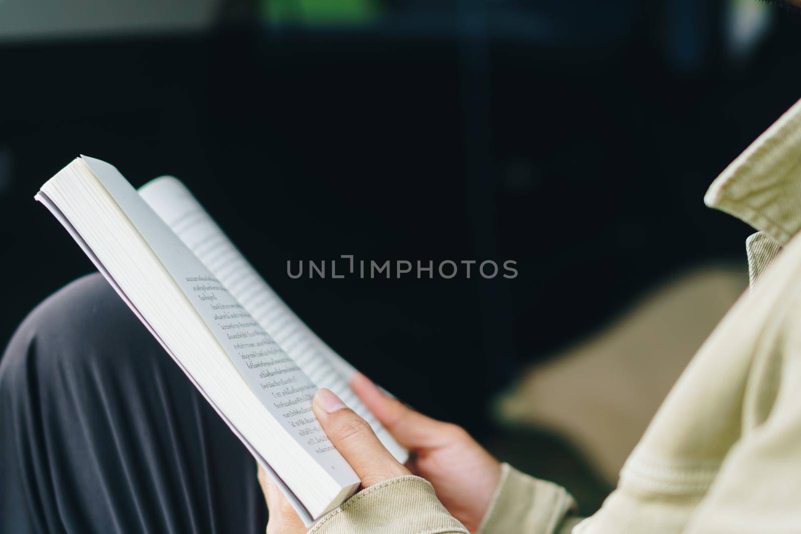 A person is reading book in car feel relax and peaceful environment background.