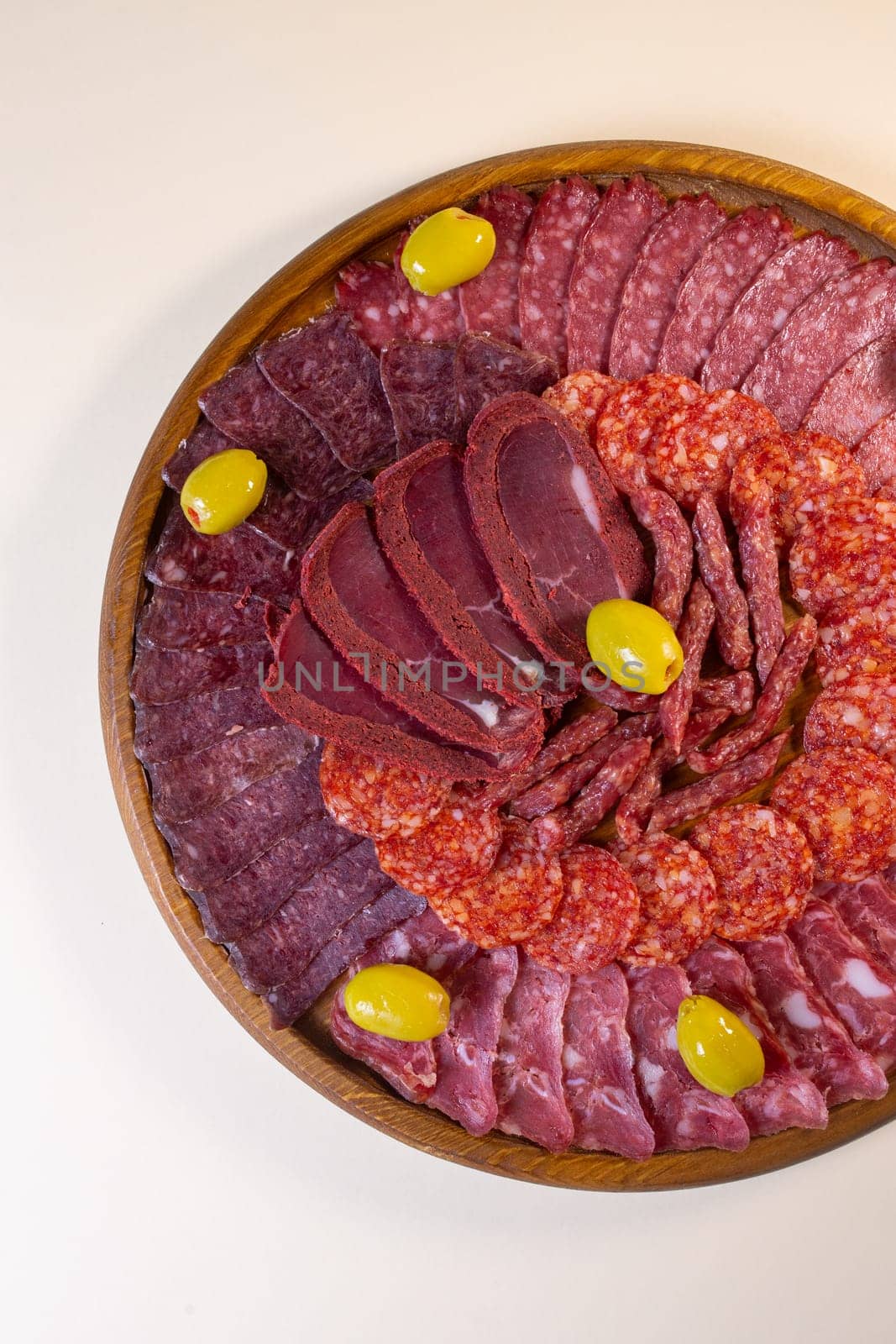 meat sliced from delicacies on a wooden stand top view.