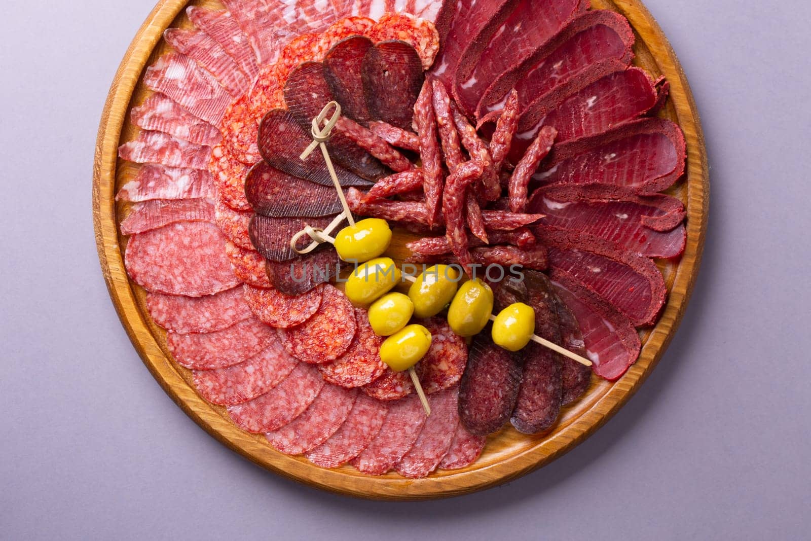 meat sliced from delicacies on a wooden stand top view.