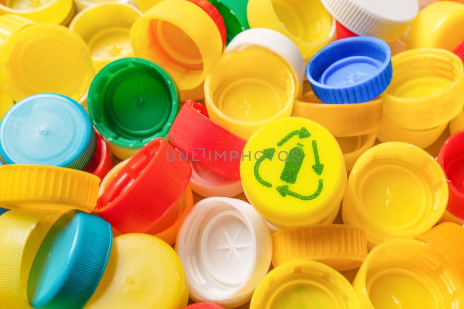Pile of plastic bottle caps icon recycle symbol reuse icon bottle cap recycling plastic caps pile. Garbage PET plastic waste sorting icon PET recycling concept