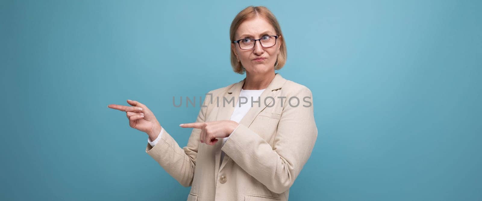 portrait of a business mature adult woman in a classic jacket on a bright background with copy space by TRMK