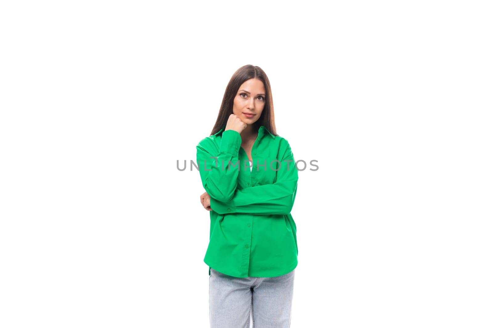 well-groomed bright young brown-haired female model with brown eyes in a green shirt posing on a white background with copy space.