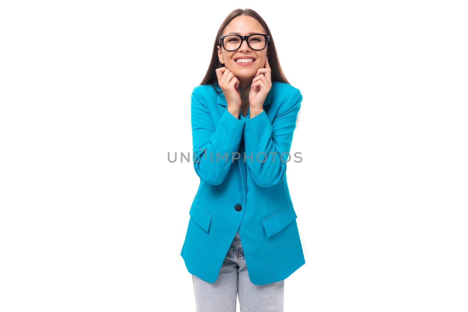 young pretty office worker woman in a blue business jacket looks successful and happy on a white background with copy space.