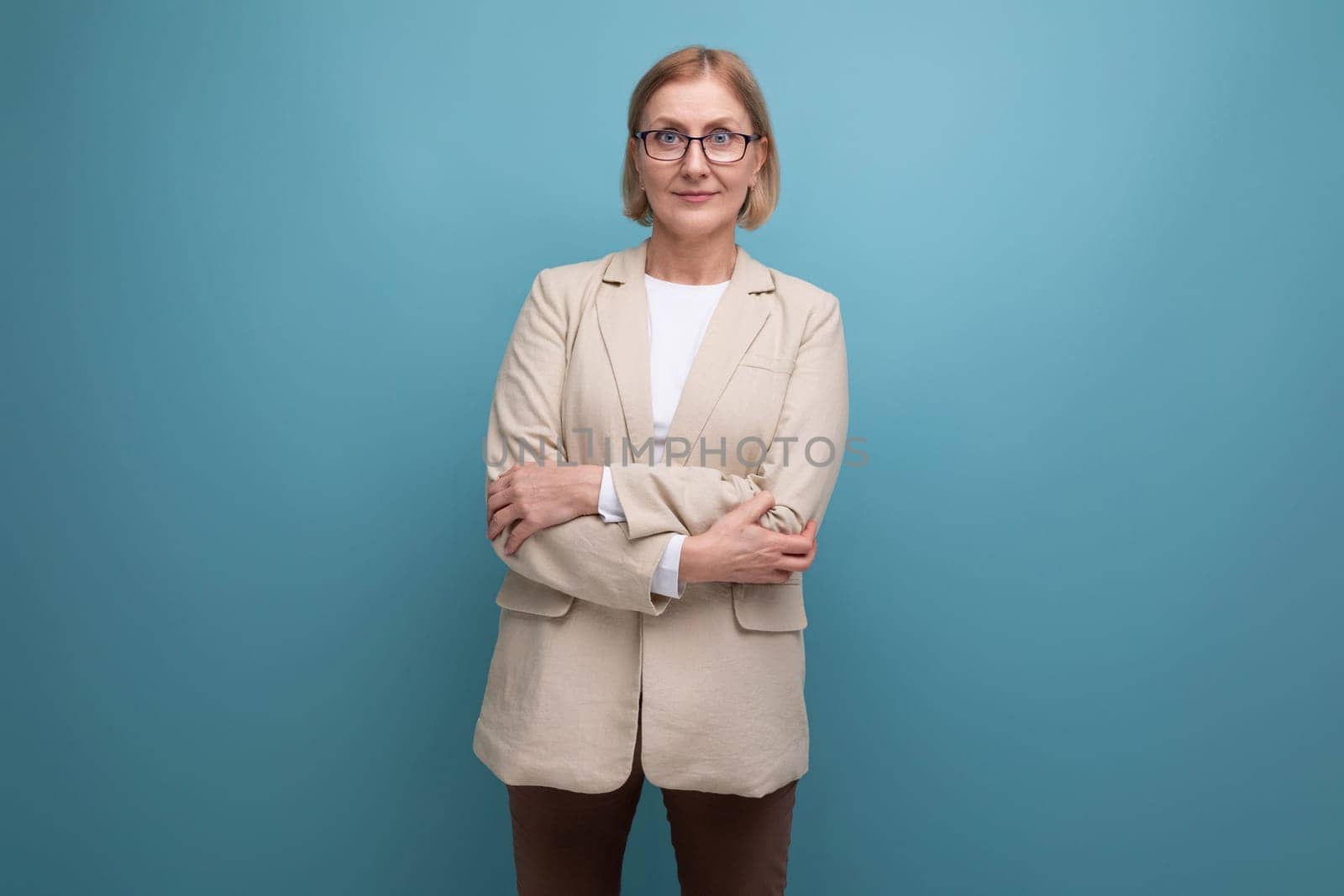 portrait of a confident mature business lady in a classic jacket on a bright background with copy space.