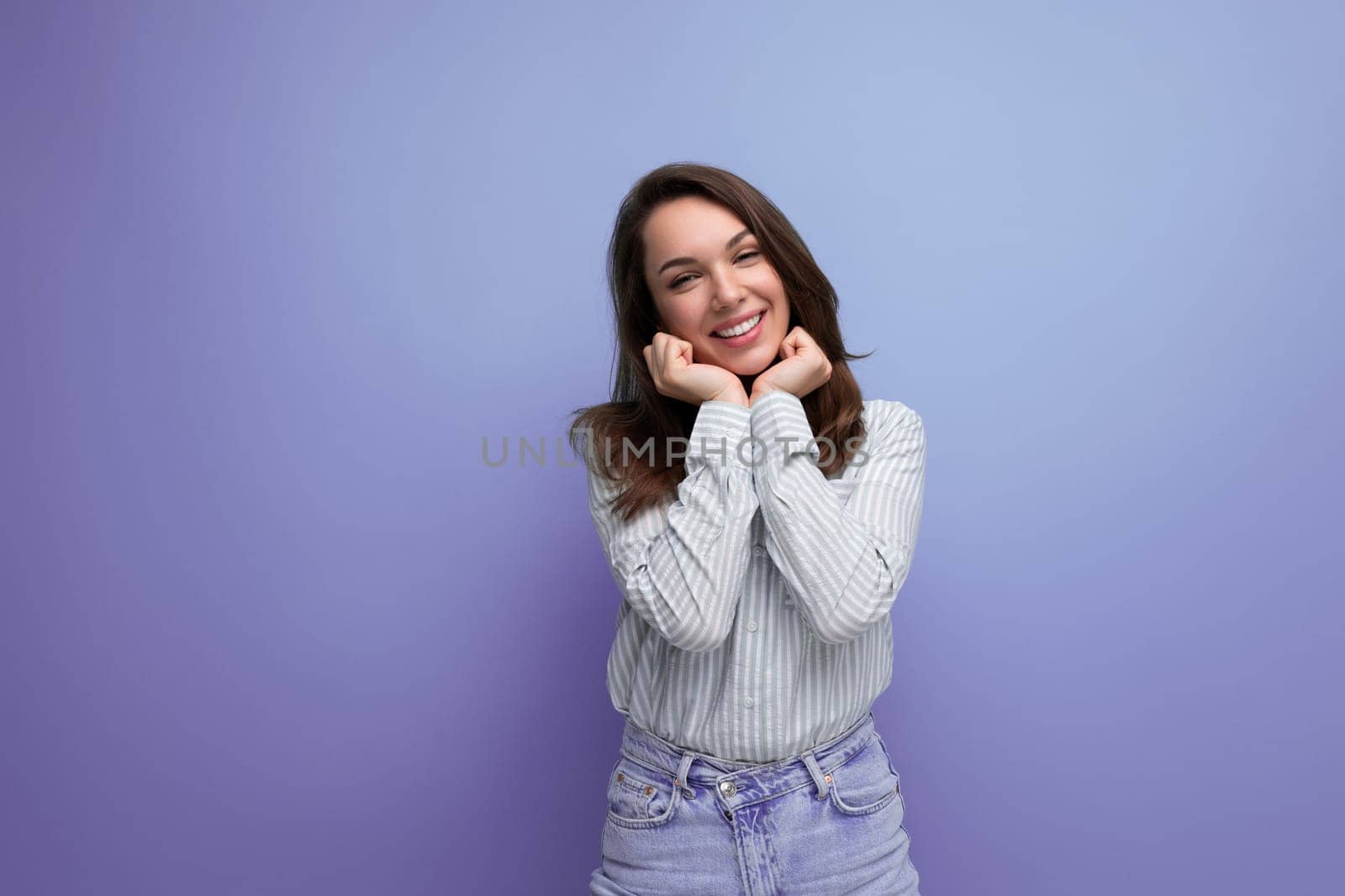 young brown-haired woman smiling coquettishly.