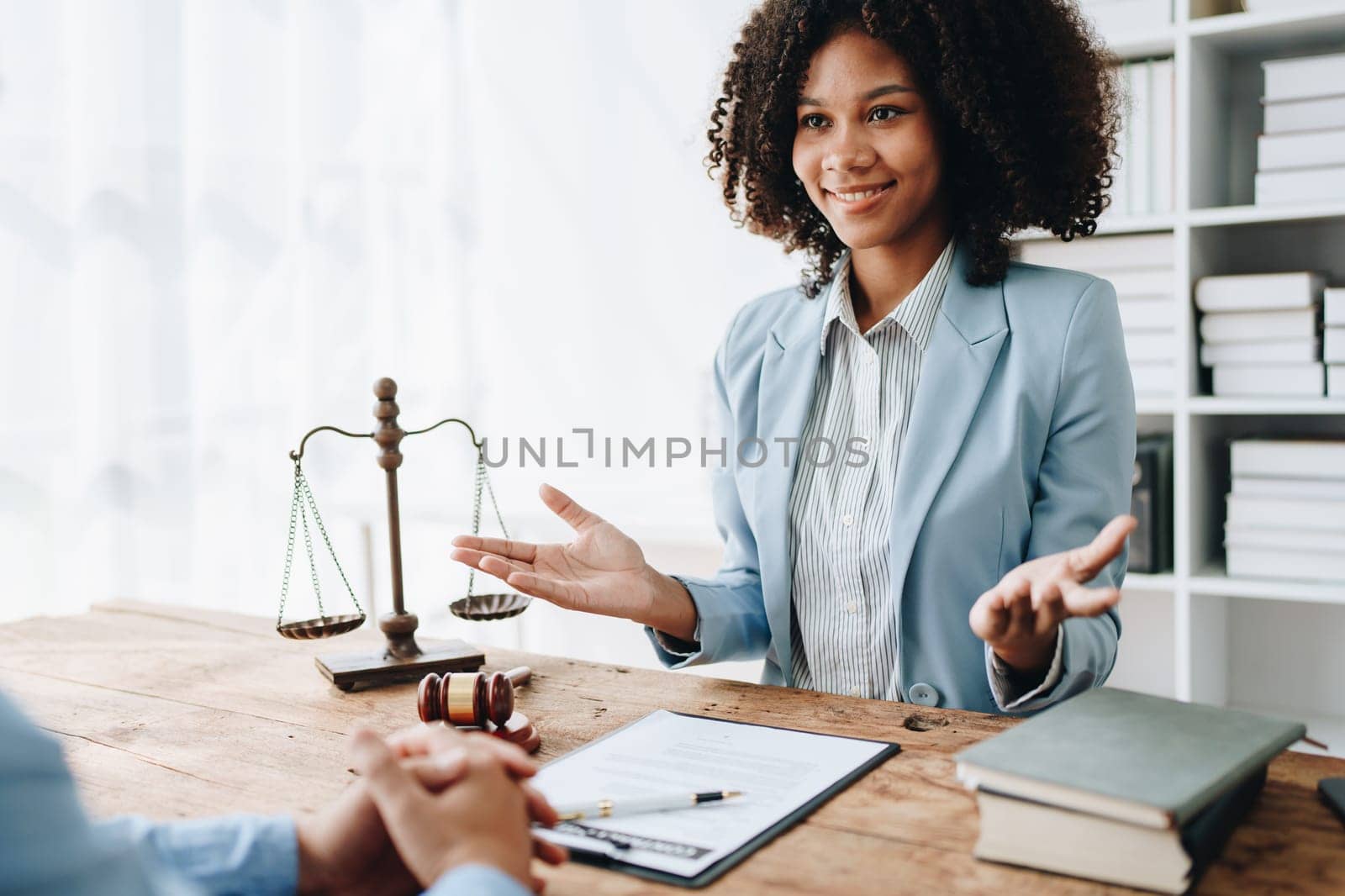 Portrait of african american woman lawyer studying lawsuit a for a discussing client documents law data before going to court. by Manastrong