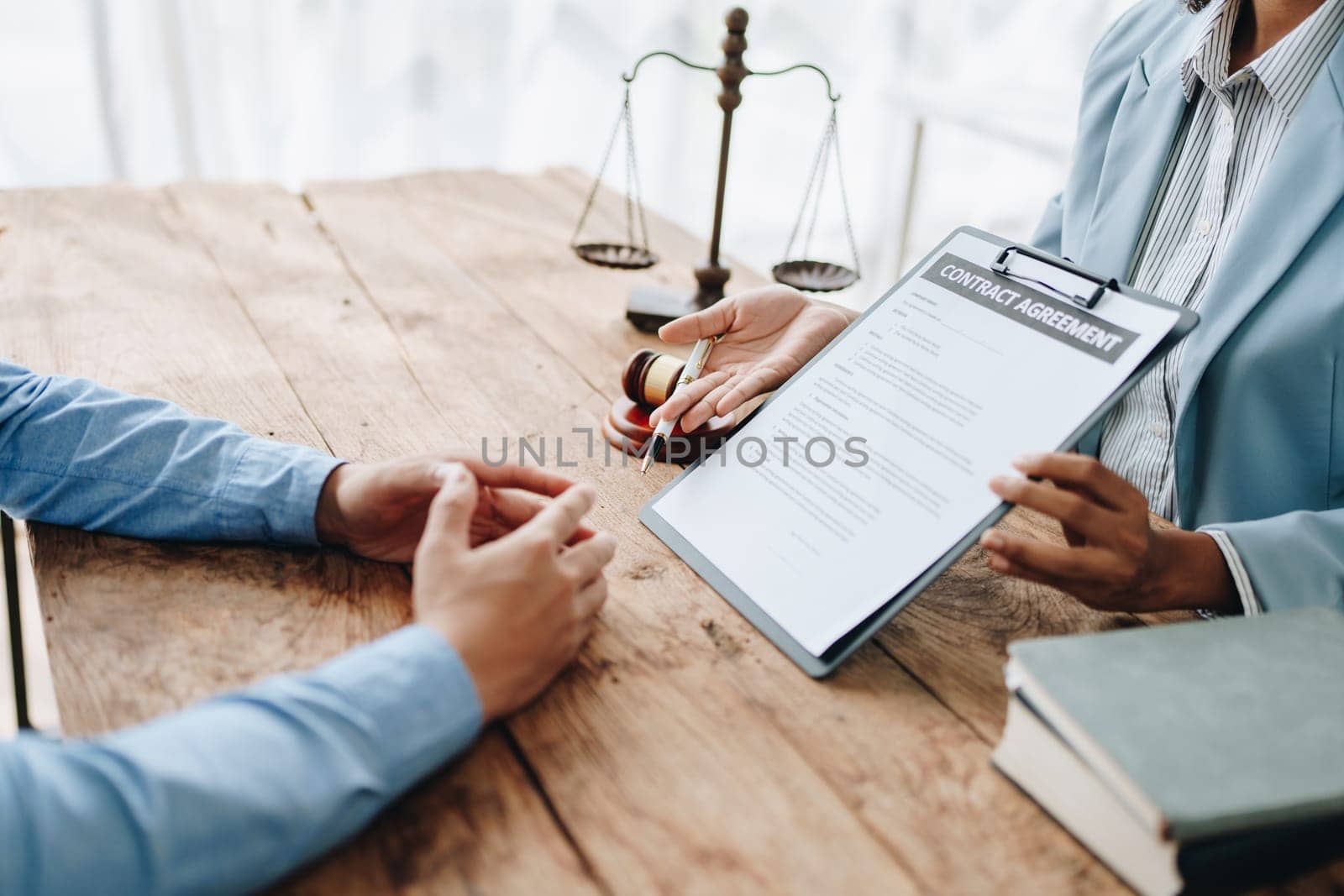 Young African American lawyer studying a case for a client and signing a legal contract to fight her opponent in court. Legal and lawyer concepts