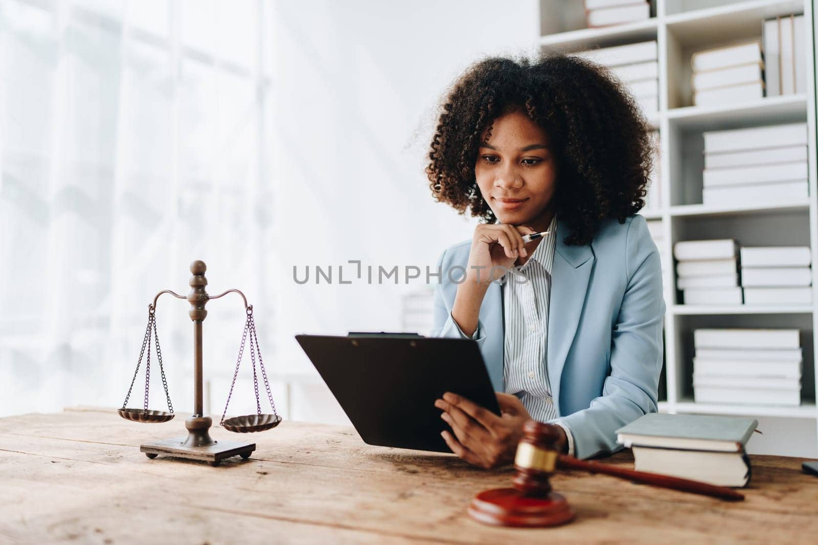 A young women African American lawyer lawsuit studying cases for clients in a law firm to fight against their parties in the courts. law and attorney concepts
