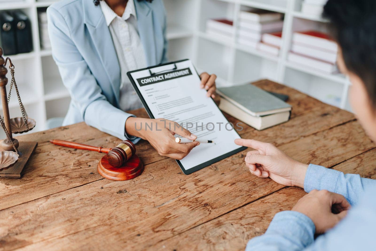 Young African American lawyer studying a case for a client and signing a legal contract to fight her opponent in court. Legal and lawyer concepts