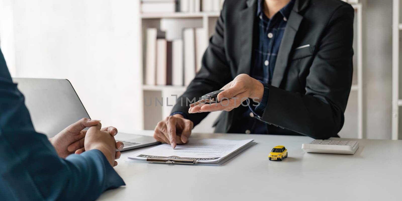 Transportation sell automotive business concept. Close up hands of sell auto agent giving car remote key to client to travel sightseeing by nateemee