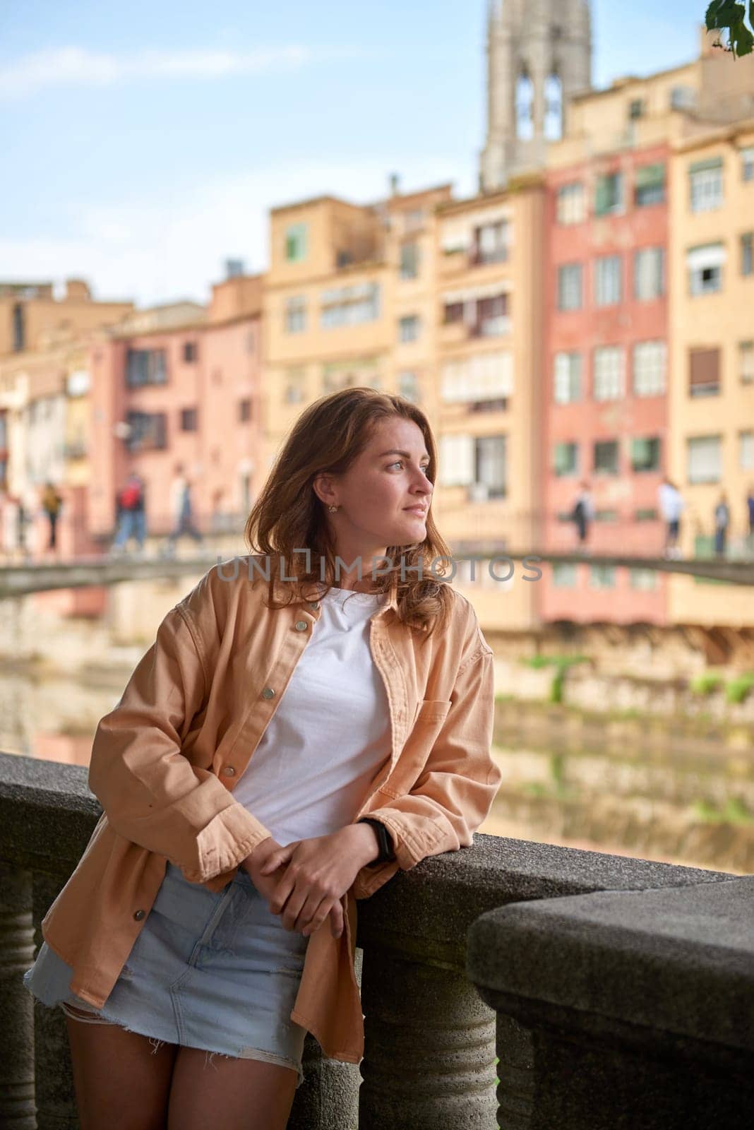 Tourist beautiful woman in Girona, Catalonia, Spain near of Barcelona. Famous resort destination in Costa Brava. Portrait of sexy woman posing at the town. Beautiful girl on the empty street in old town. Travel girl in Spain, Barcelona. Summer time vacation by Andrii_Ko