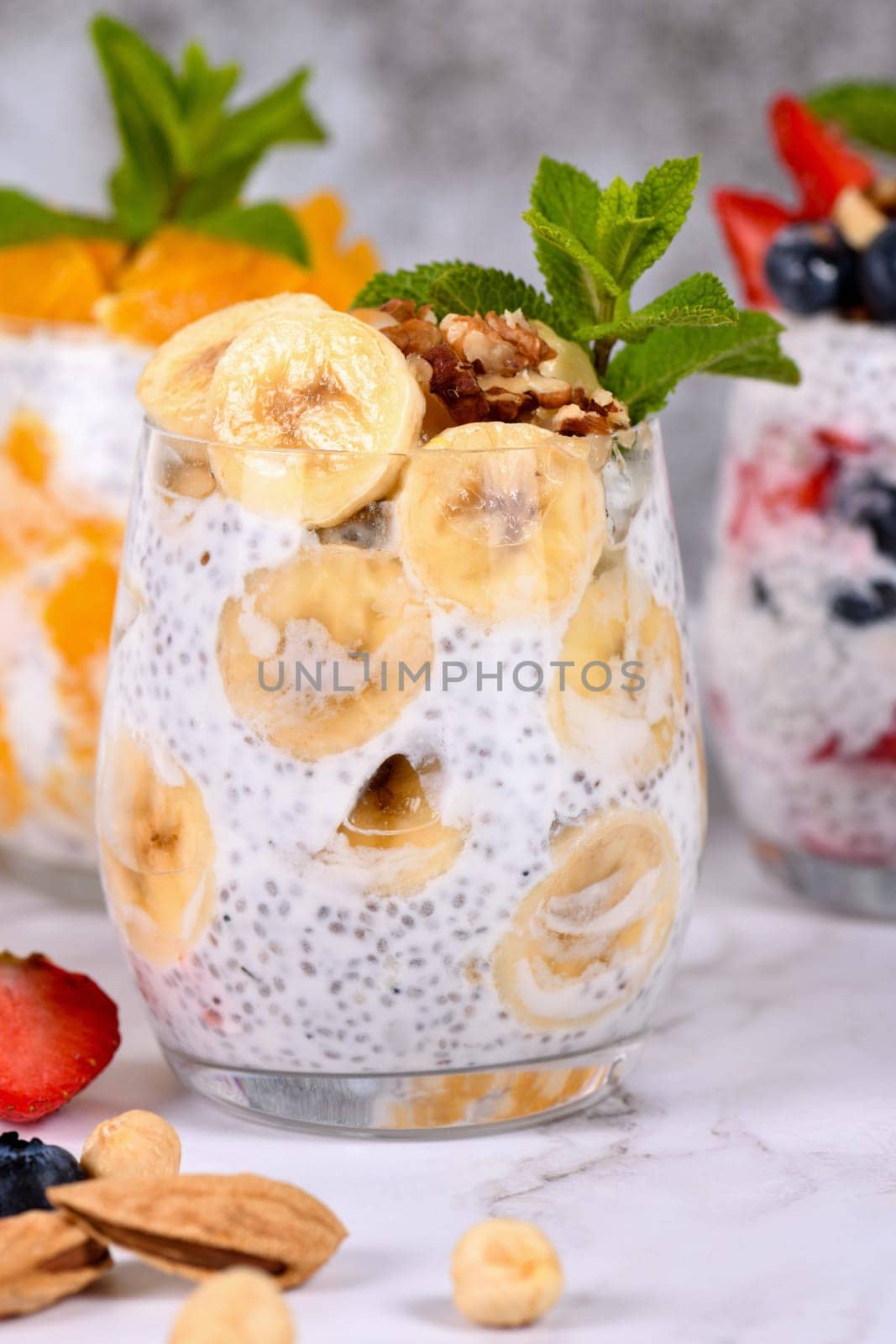 Chia dessert with Greek yogurt and banana slices and nuts. Absolutely helpful. Perfect breakfast or snack. Suitable for vegans and gluten free.