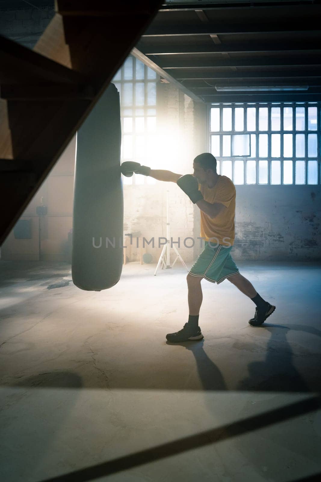 Young man boxing workout in an old building. High quality photo