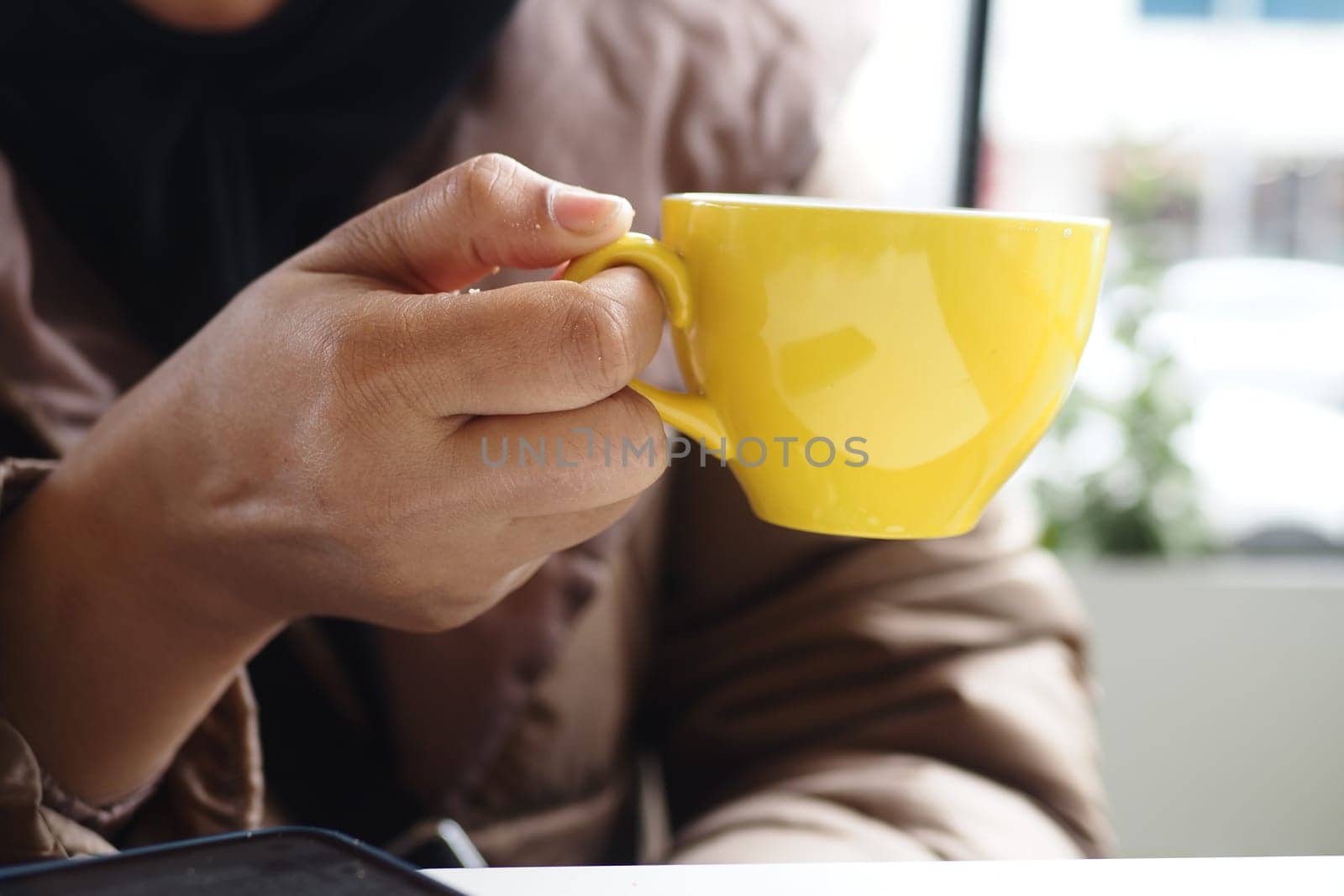 women holding a coffee cup .