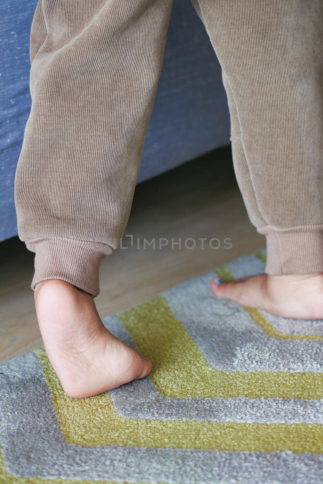 low angle view of A child walking on tiptoes.