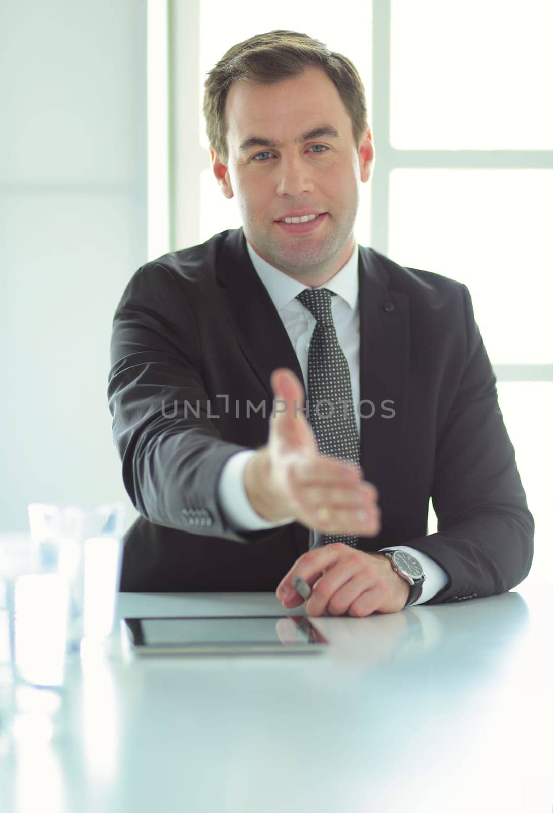 Portrait of businessman giving hand for handshake. by lenets