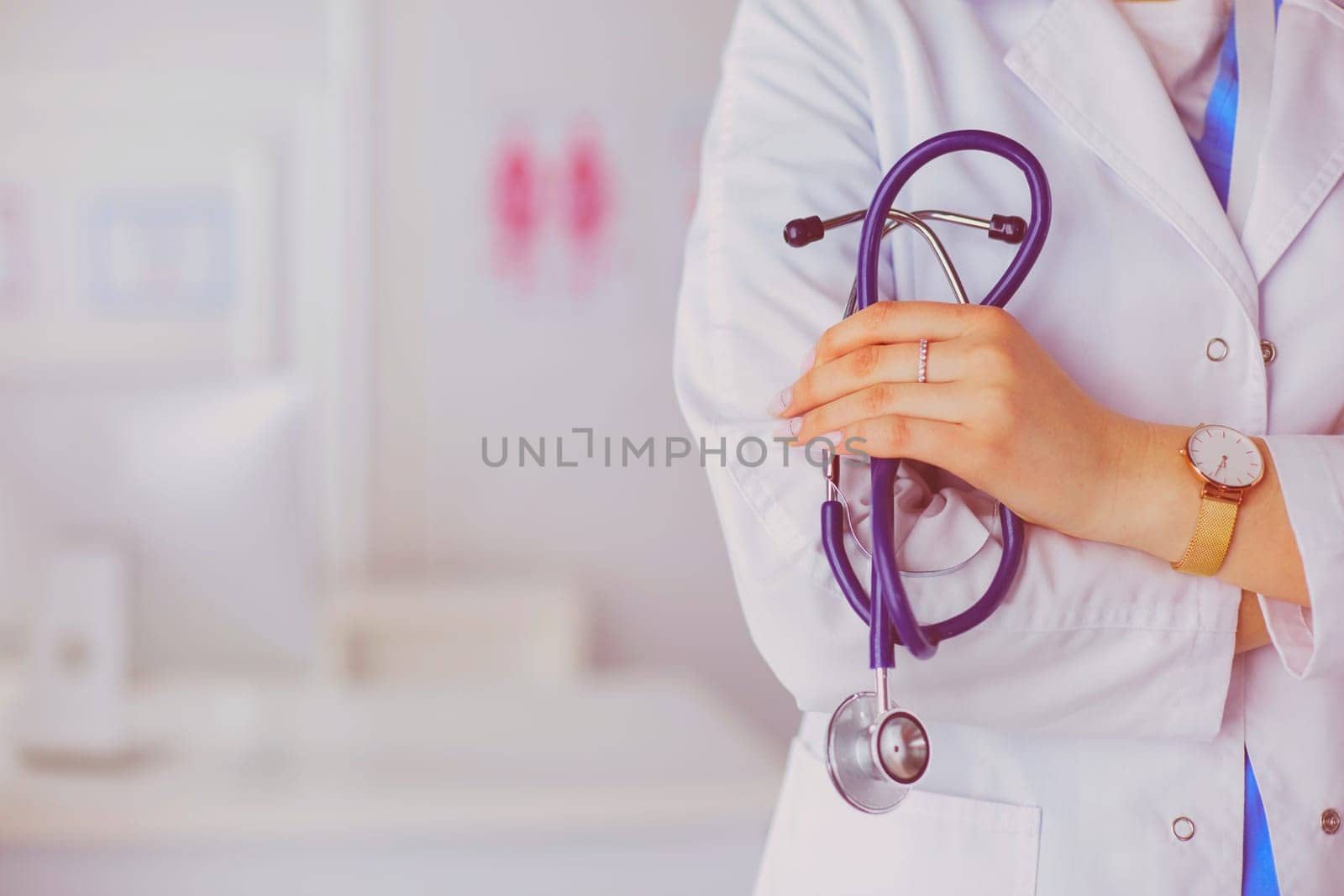 Smiling medical doctor woman with stethoscope in hospital by lenets