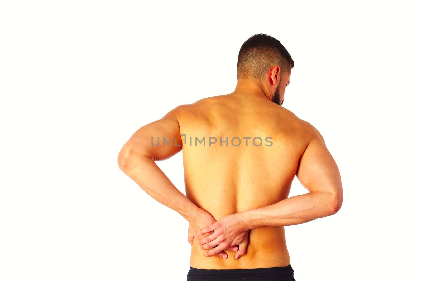 Young man holding his neck in pain. Medical concept by lenets