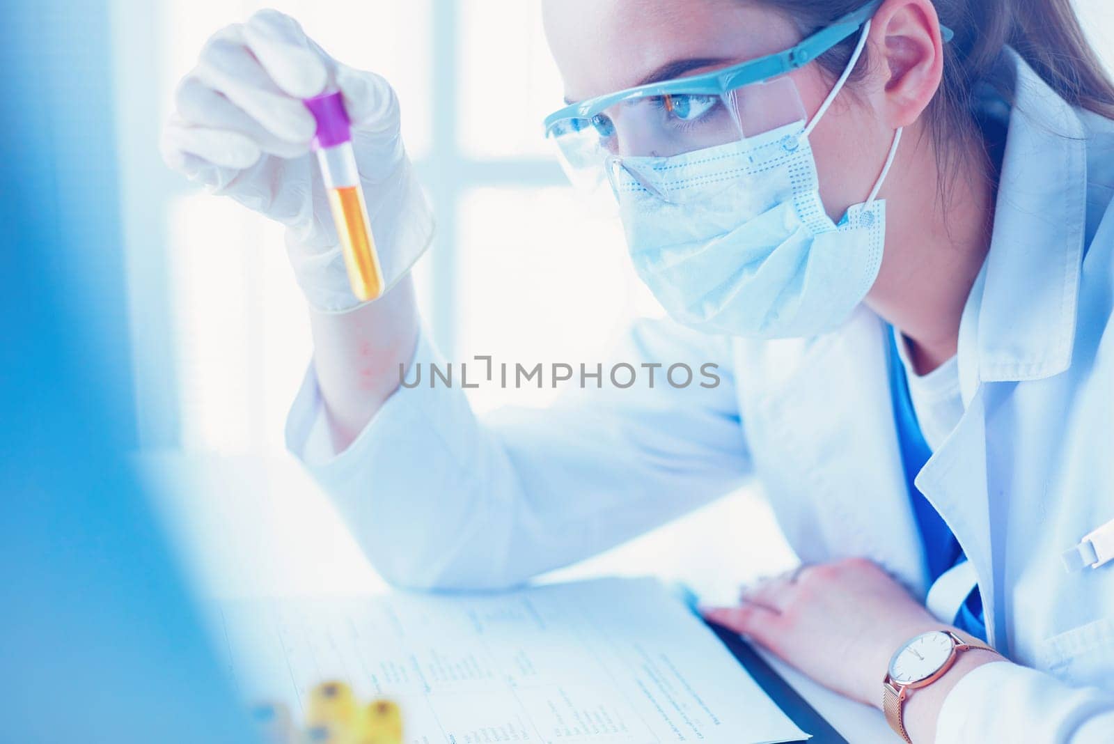 Researcher, doctor, scientist or laboratory assistant working with plastic medical tubes in modern lab or hospital.