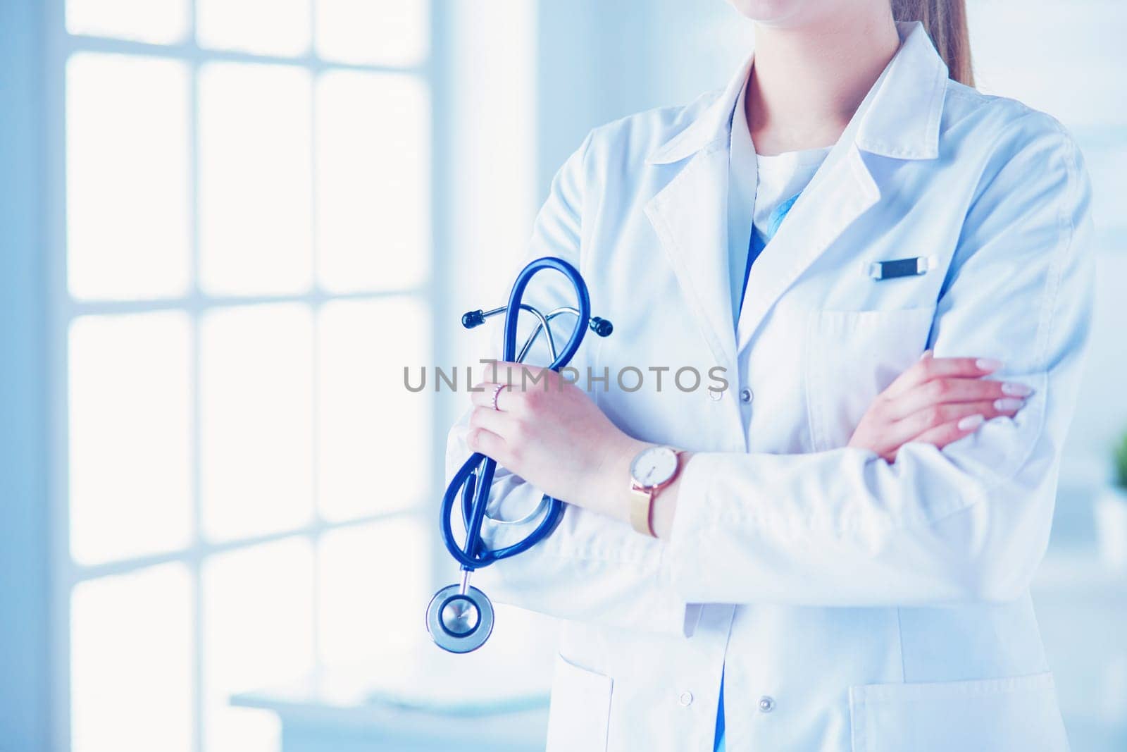Smiling medical doctor woman with stethoscope in hospital.