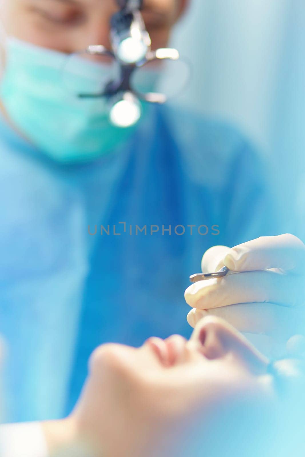 Man surgeon at work in operating room.