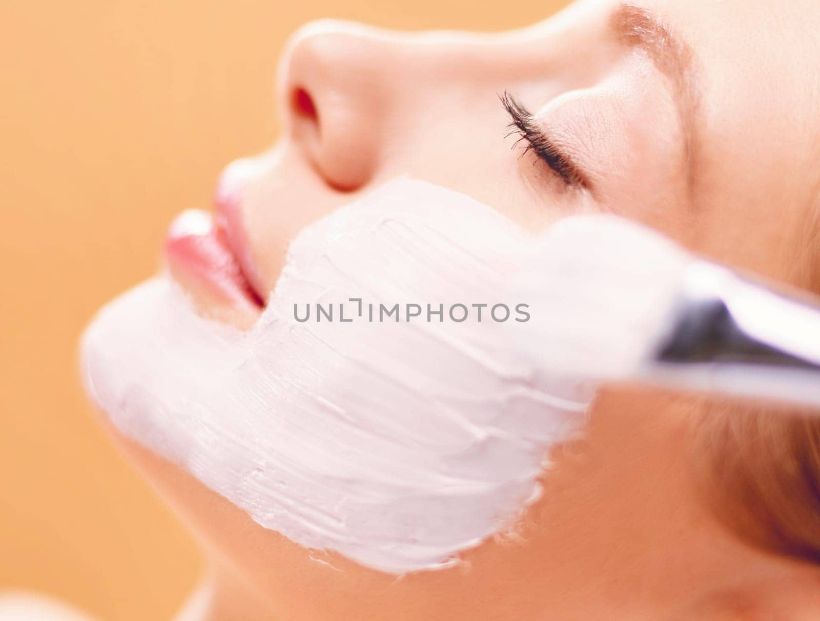 Spa facial mask application. Spa beauty organic facial mask application at day spa salon.