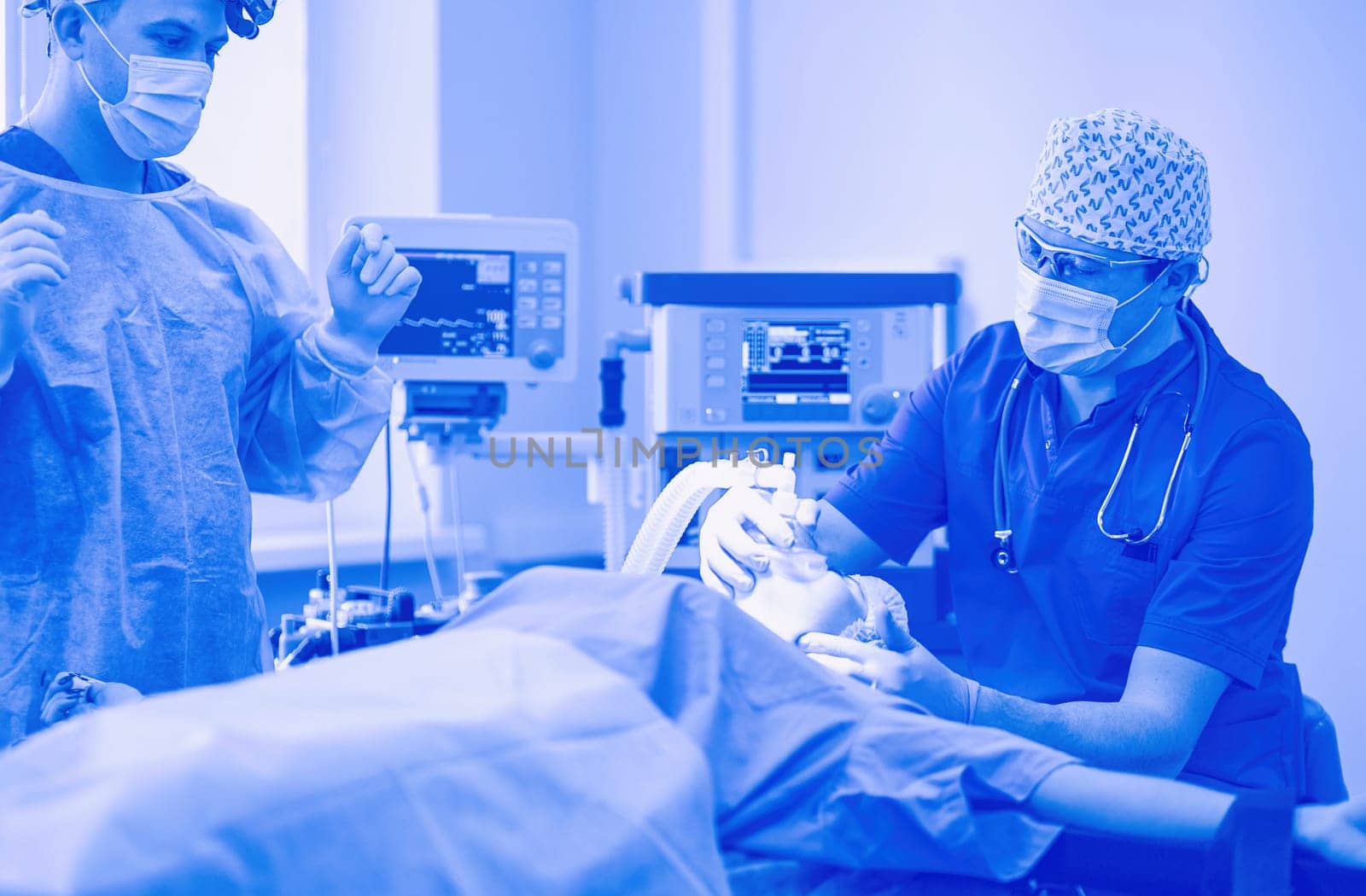 Man surgeon at work in operating room.