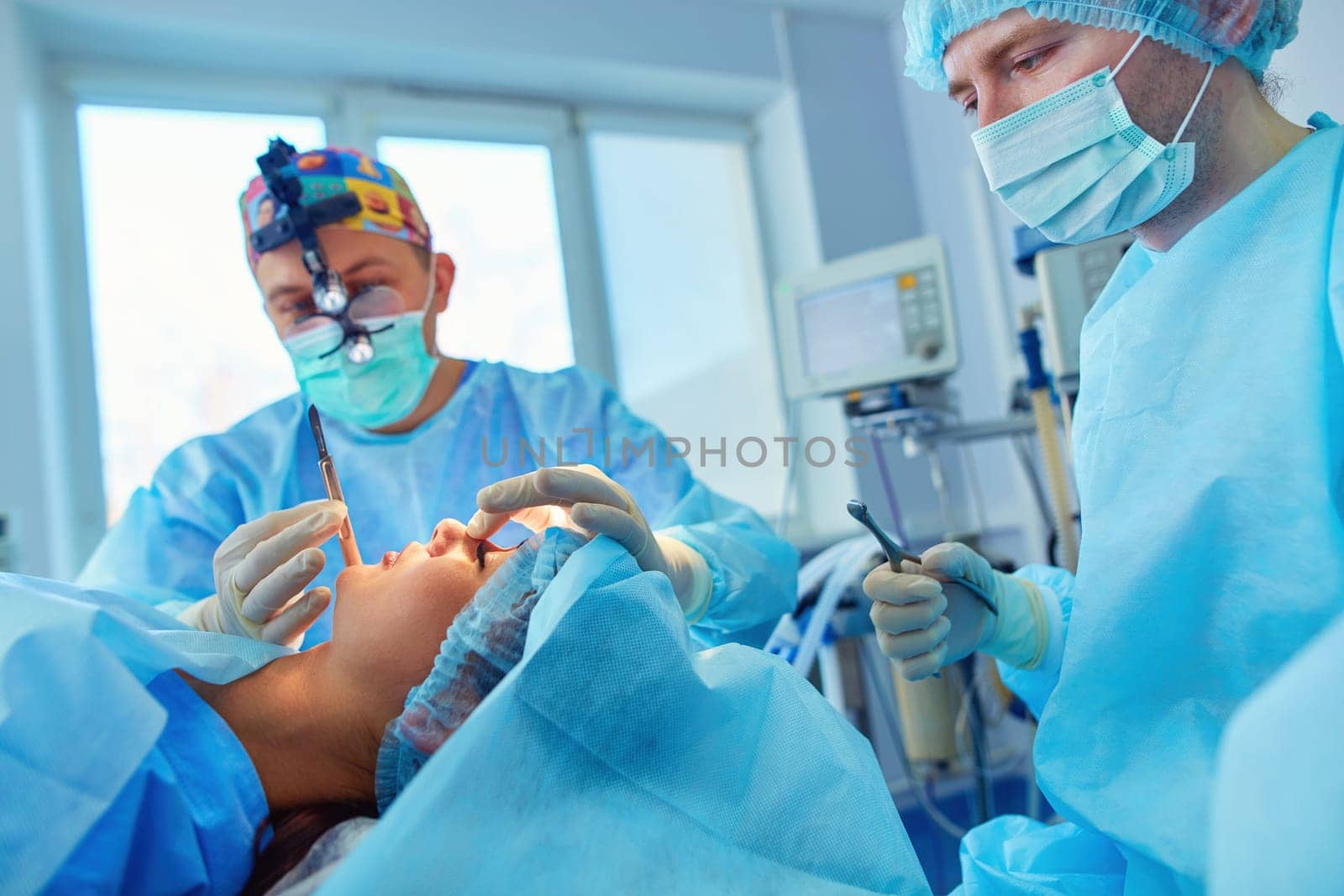 Man surgeon at work in operating room.