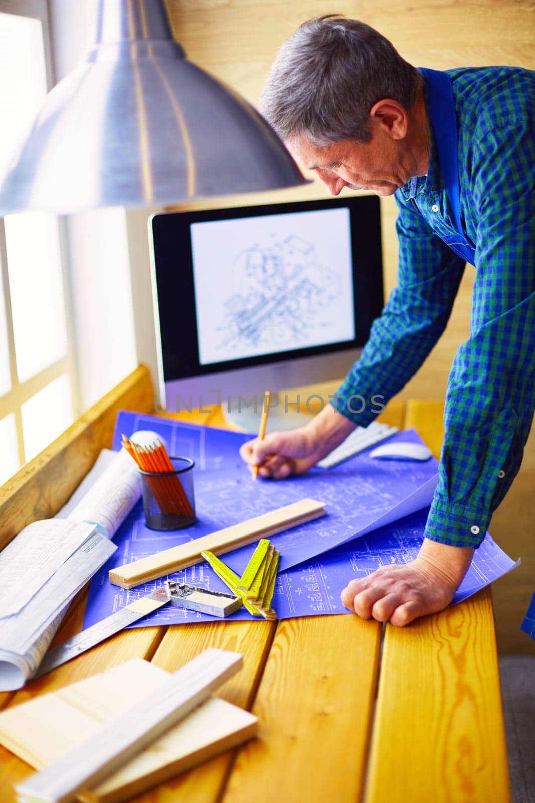 Architect working on drawing table in office.