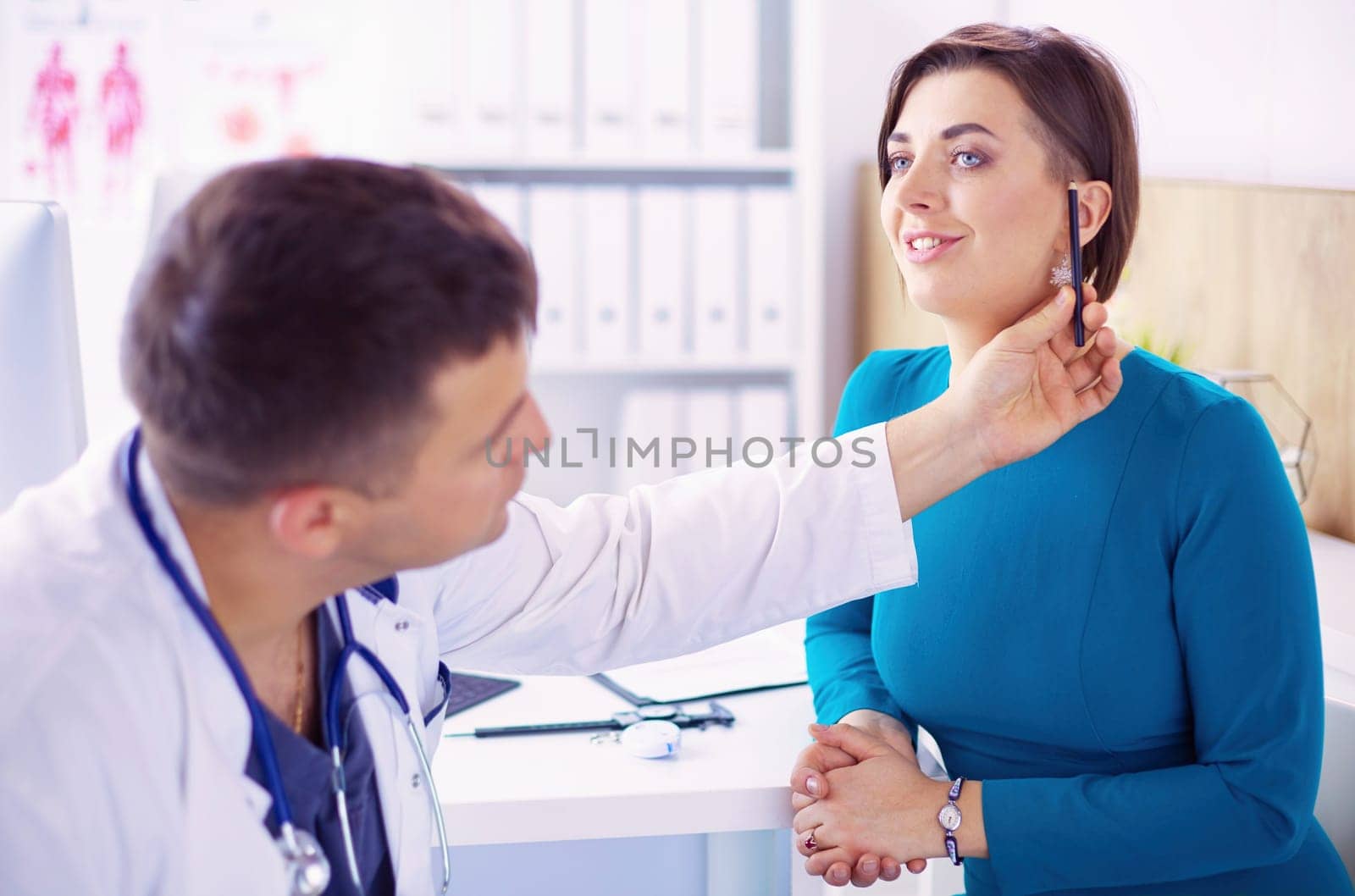 The patient and his doctor in medical office.