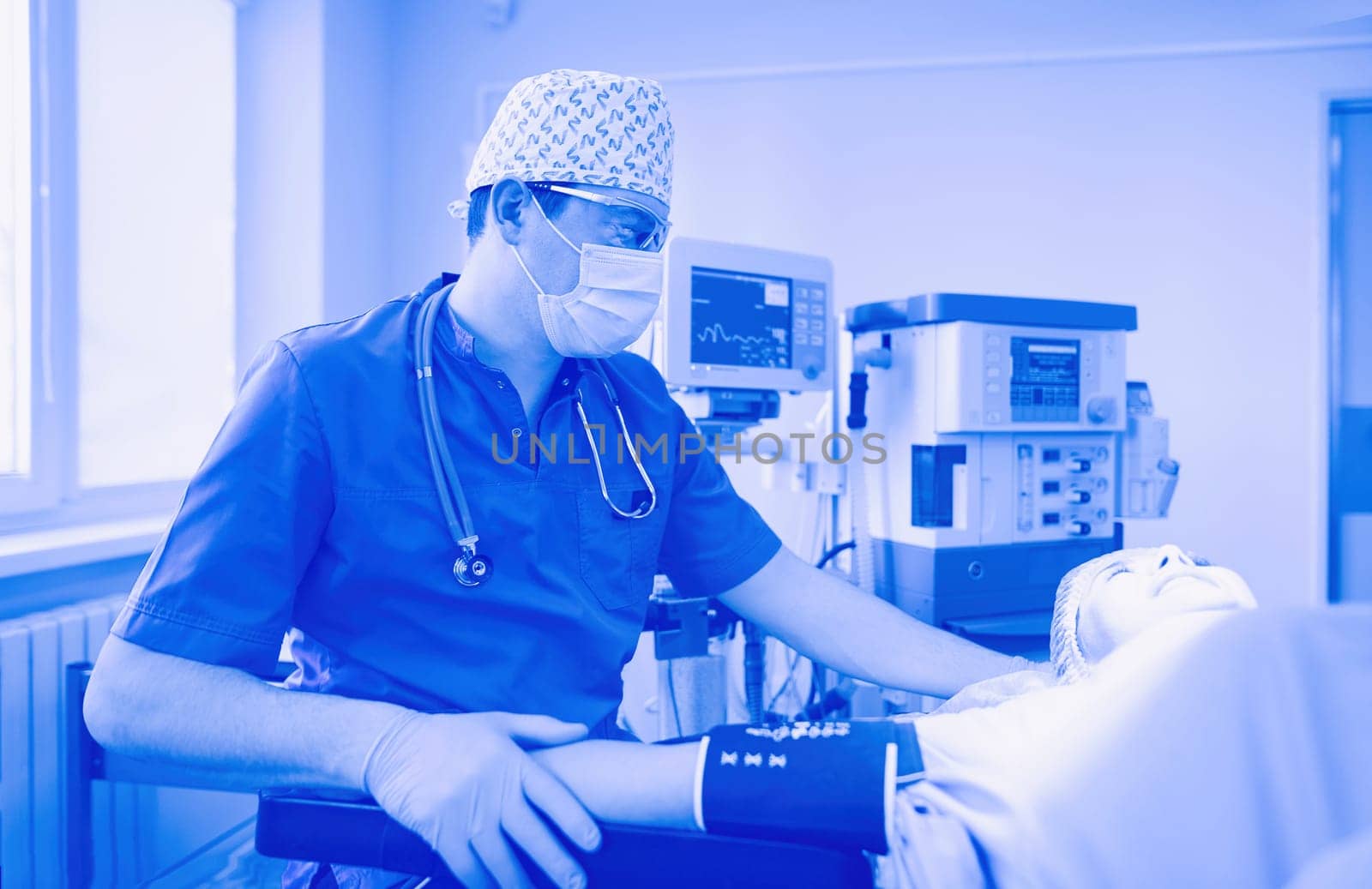 Man surgeon at work in operating room.