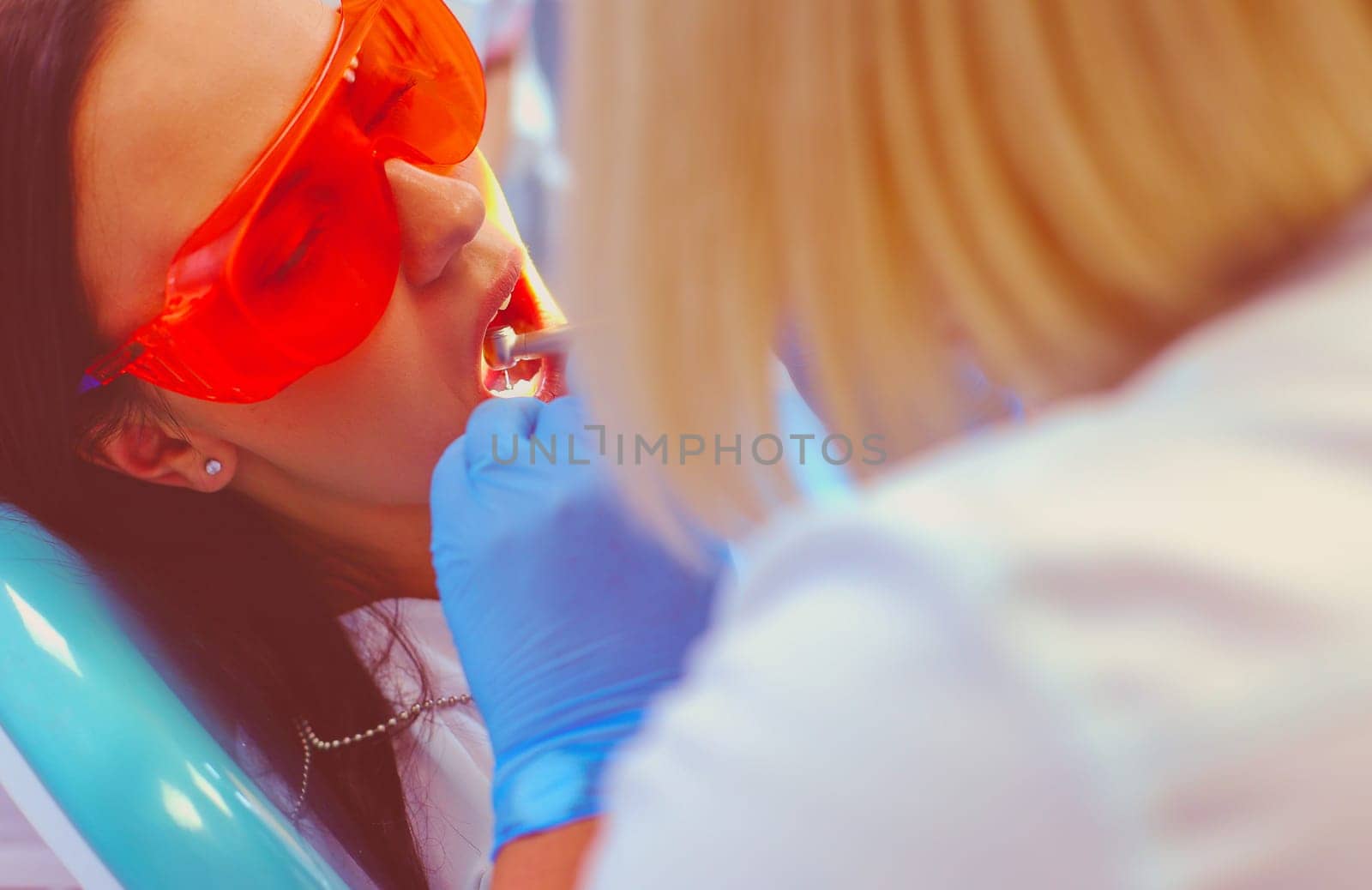 Young woman dentist at work in the office.