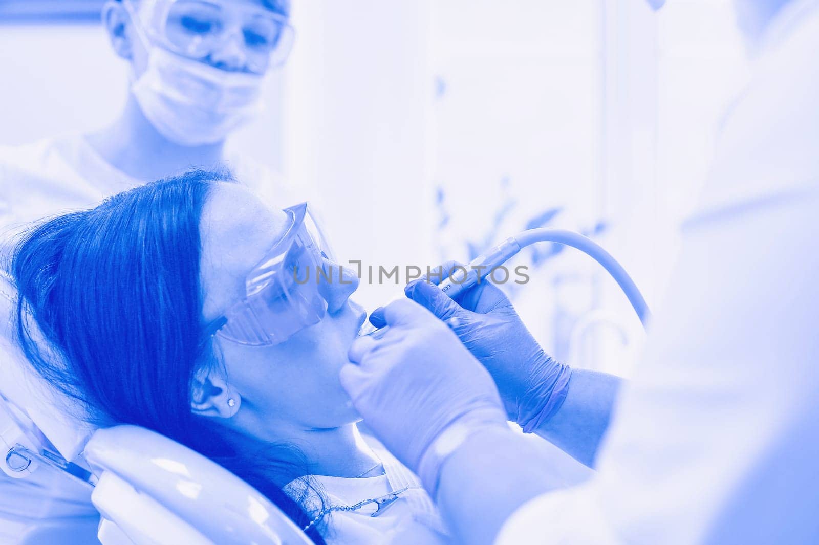 Young woman dentist at work in the office.