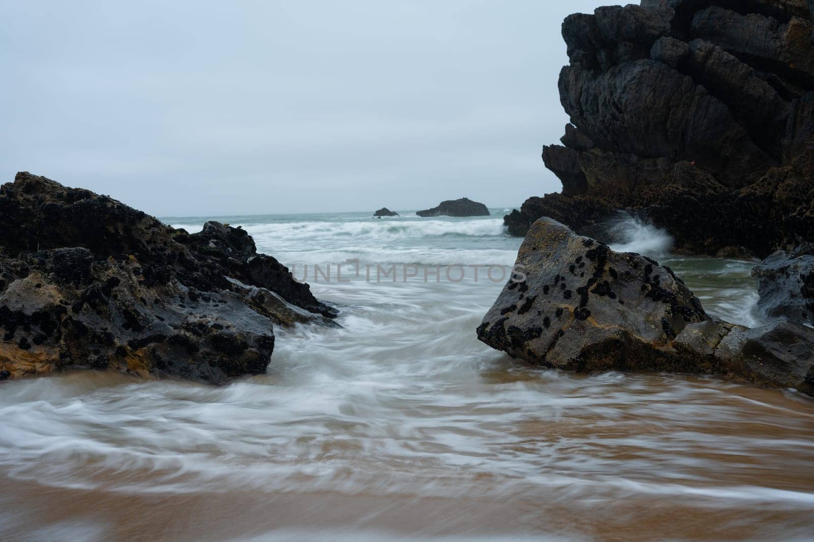 long exposure waves crashing coast movement white wave crashing rock in the dusk evening time