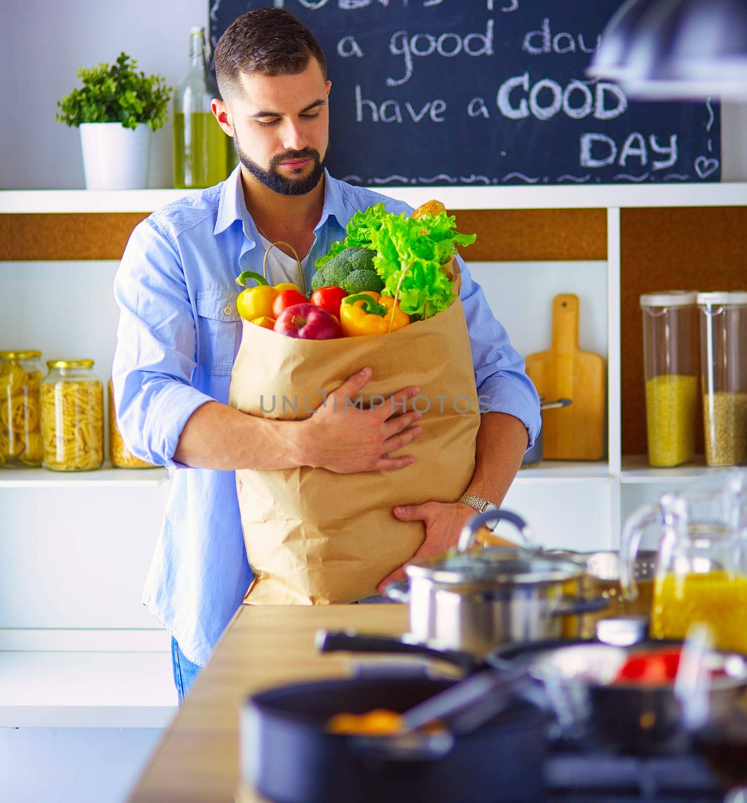 Man preparing delicious and healthy food in the home kitchen.