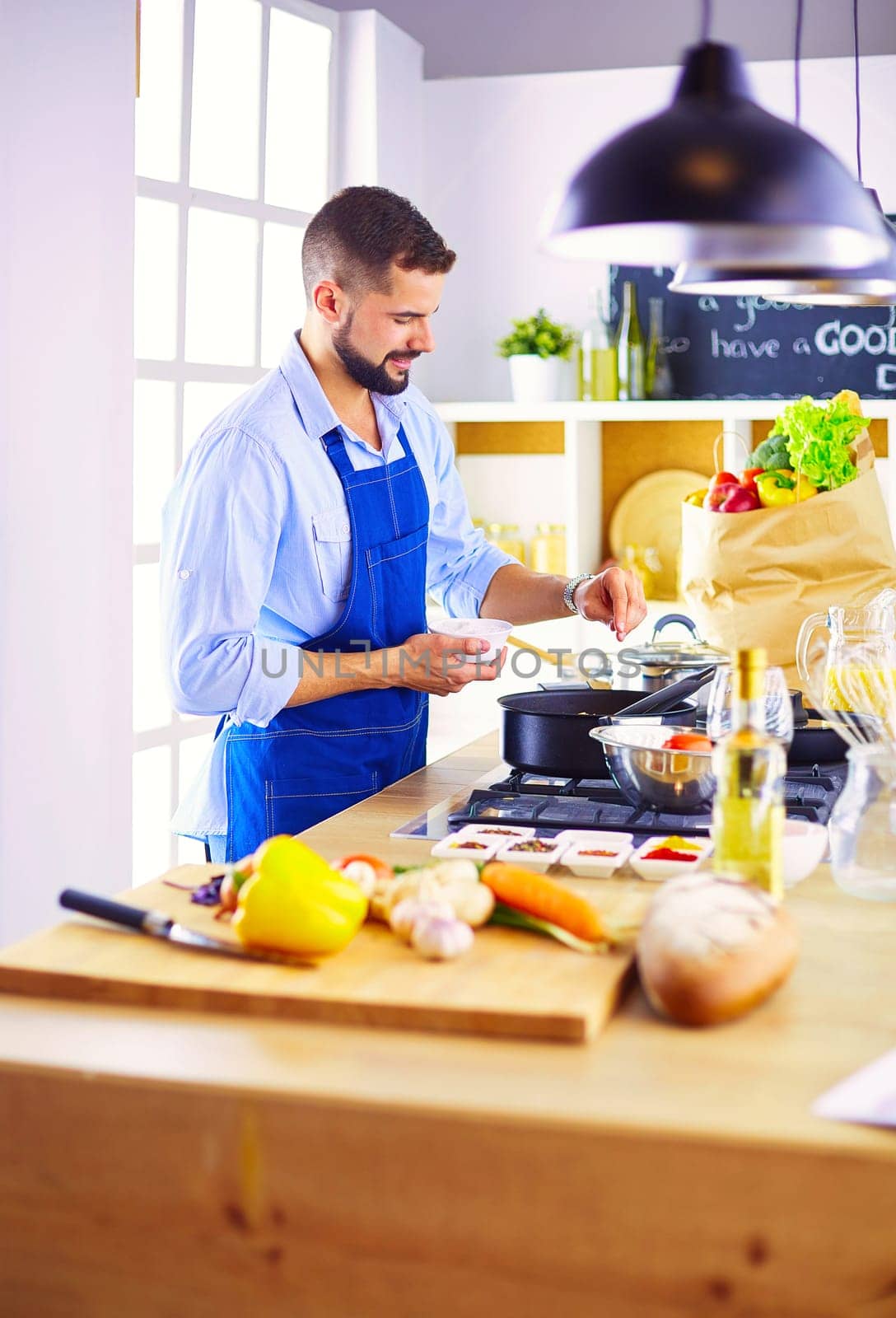 Man preparing delicious and healthy food in the home kitchen.