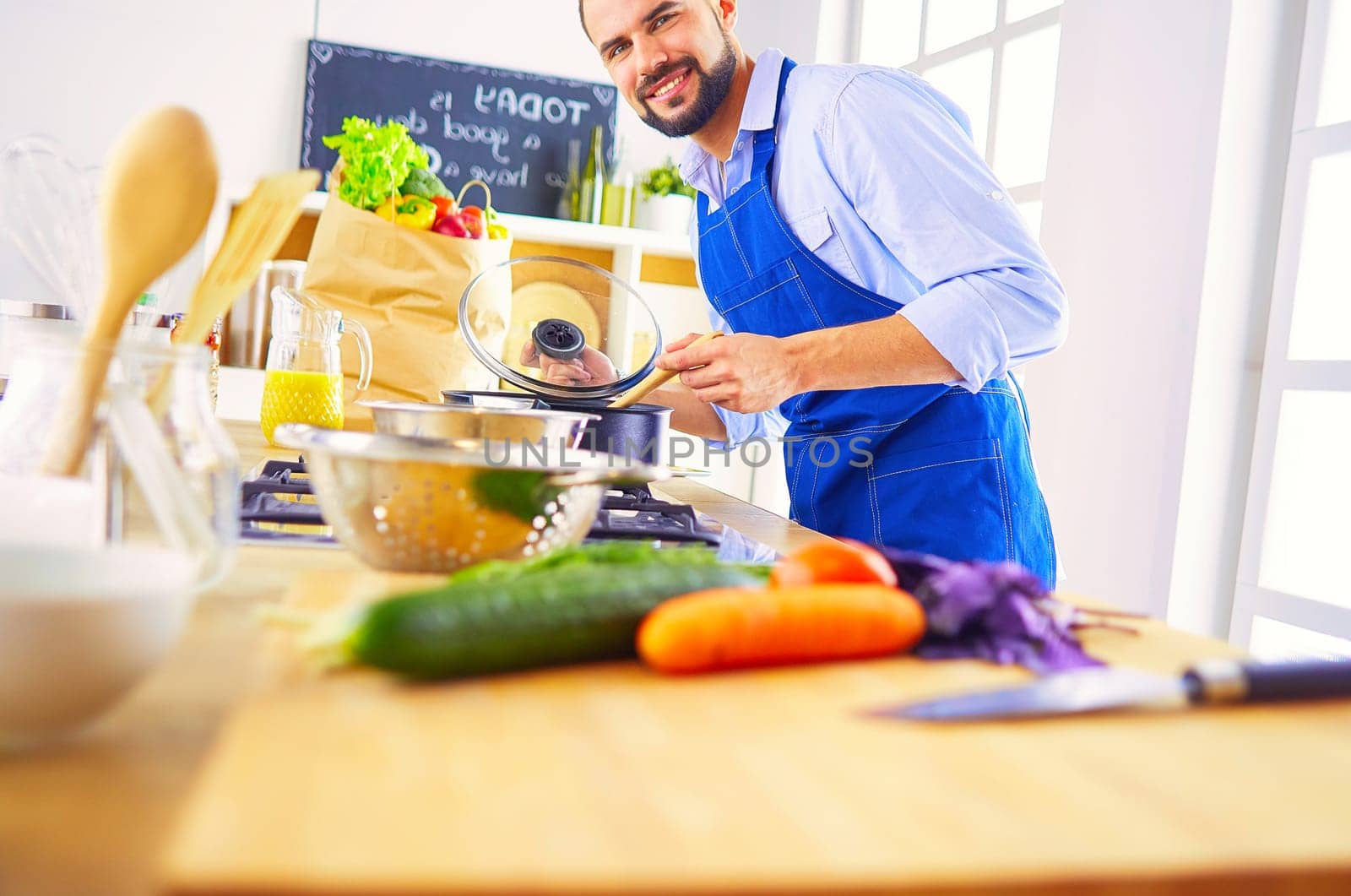 Man preparing delicious and healthy food in the home kitchen.